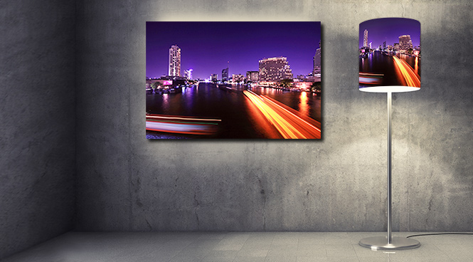 A glowing cityscape on wallart as well as on a lampshade as a creative photo gift