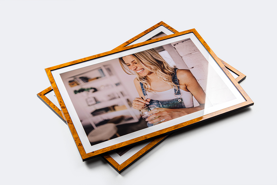 Portrait of a blonde woman as framed wall art in a wooden frame